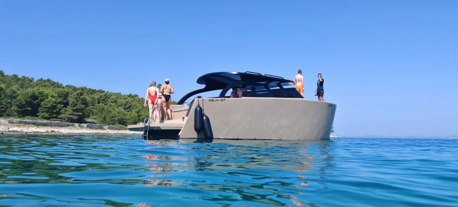 Climbing back aboard the Felix 37 after a swim stop