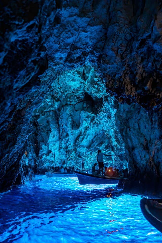 Sunlight glowing electric blue inside the Blue Cave on Biševo island