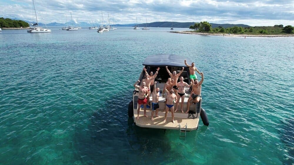 Private boat tour guests enjoying the sun on deck off the coast of Dalmatia