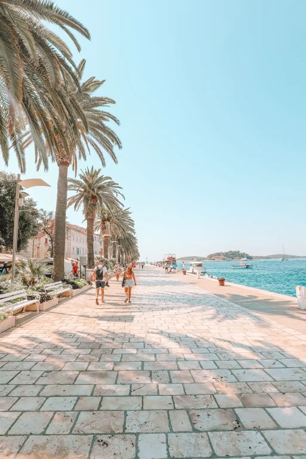 Strolling the palm-lined waterfront after a day on the water