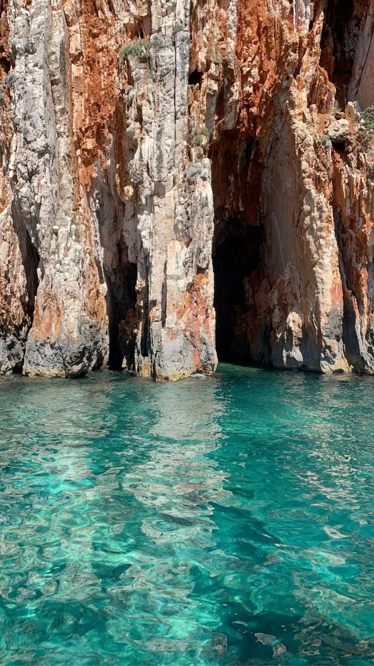 The dramatic limestone arch of Red Rocks rising from turquoise water