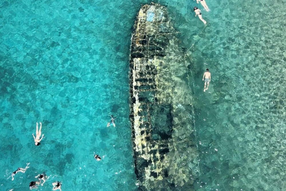 Swim above the Šolta shipwreck — a century-old hull resting just below the surface